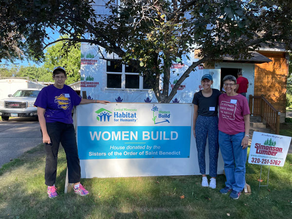 Volunteers working with Habitat for Humanity building a home