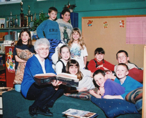 photo of Elementary teacher surrounded by students